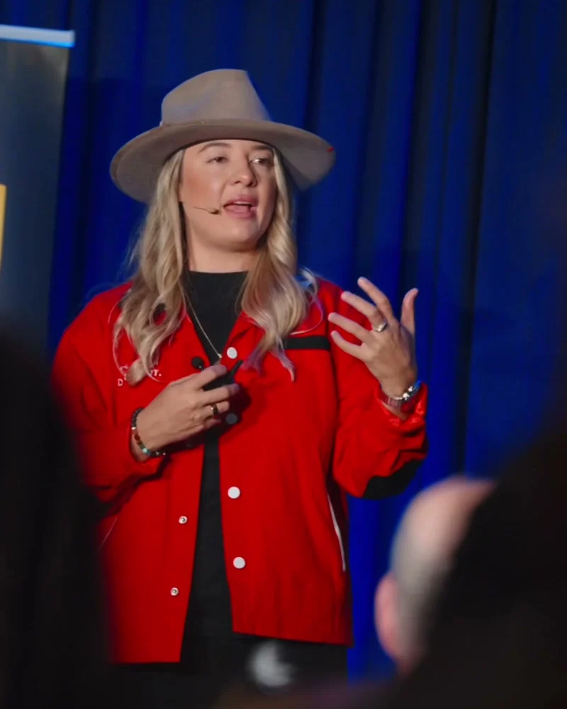 Amber Spears speaking on stage at Four Rooms Mastermind