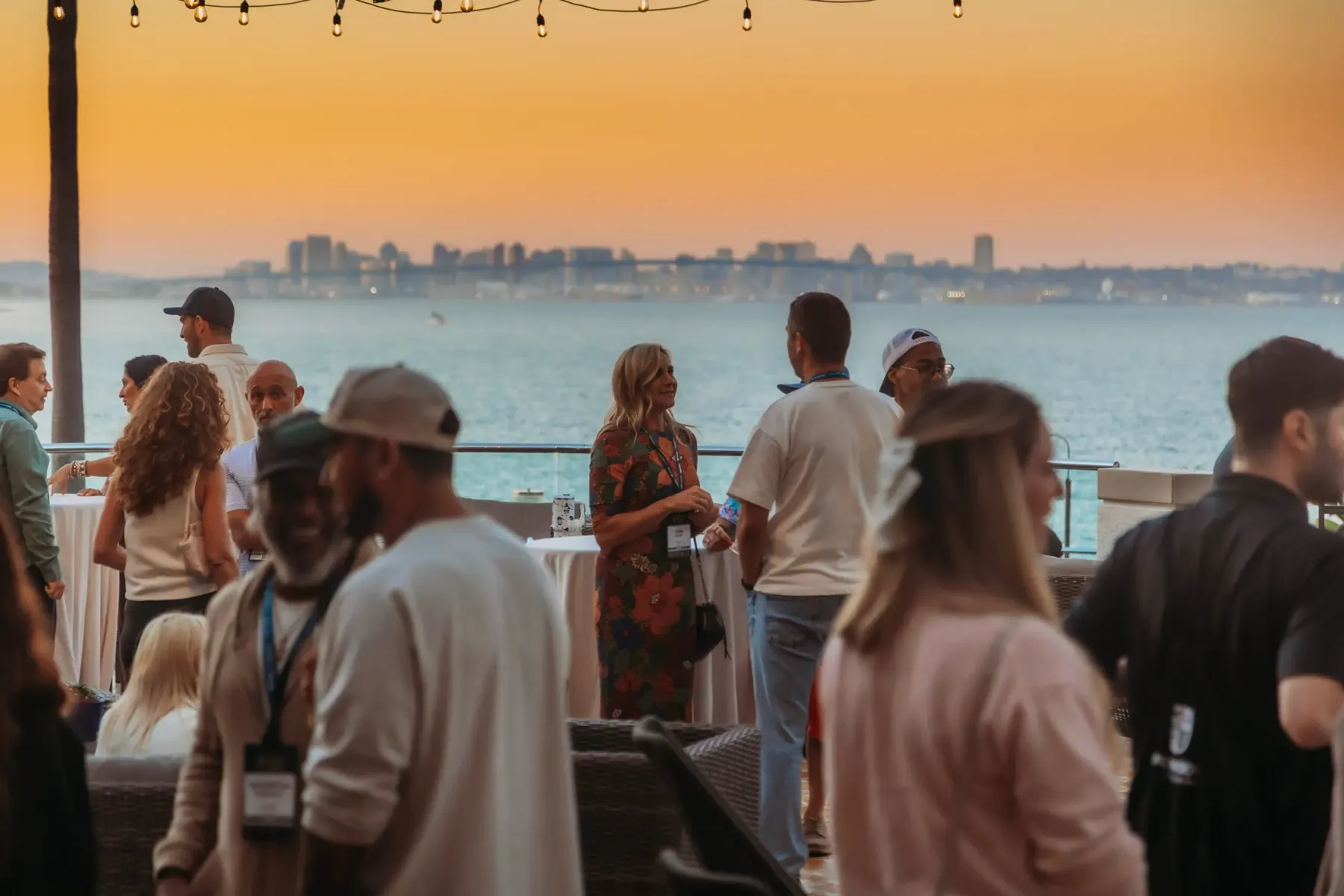 Founders networking on a terrace at sunset